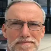Headshot of John Kell MBE CEng FWeldI FREng wearing glasses