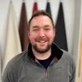 Martyn Talbot smiling in a grey quarter-zip top
